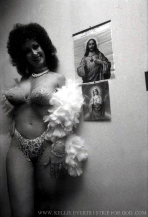 Kellie in stage costume proudly posing next to icons of her Beloved Mary of the Immaculate Heart and Jesus Christ