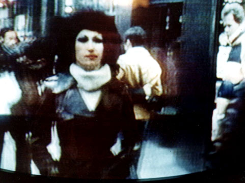 Kellie Everts the Stripper for God, followed by the TV cameras of Real People on the streets of New York City on a cold windy day