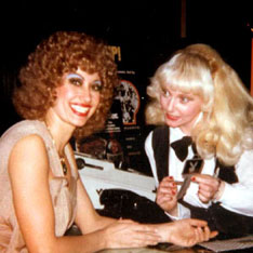 An off-stage Kellie, in full makeup and hair (beize permed wig) with a  platiinum blonde friend at the Playboy Club